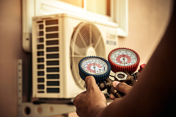 Professional Air Conditioning Service technician working in South Amana, IA